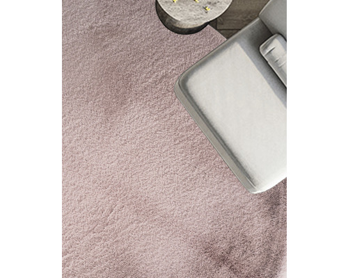 Gros plan d''un tapis à côté d''un canapé et d''une table d''appoint