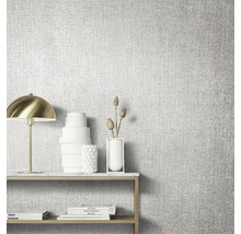 Gros plan d''un papier peint texturé dans une pièce lumineuse avec table, lampe et décoration