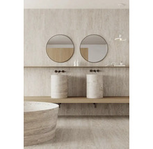 Salle de bain lumineuse avec double vasque en pierre naturelle, miroirs ronds et baignoire assortie.
