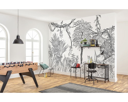 Pièce lumineuse avec baby-foot, bureau et peinture murale à motifs de jungle