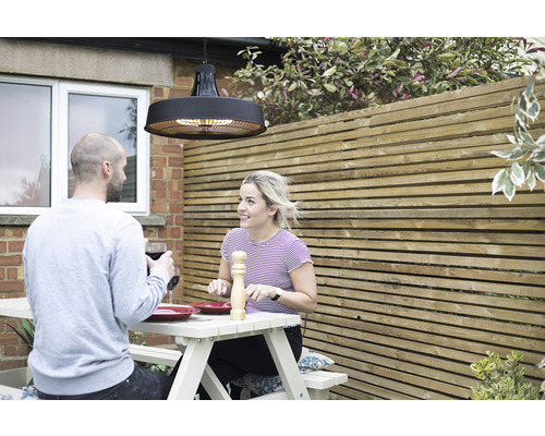 Terrassenszene mit zwei Personen unter einem Deckenheizstrahler