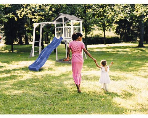 Tour de jeu avec toboggan et structure d''escalade dans le jardin, mère et fille