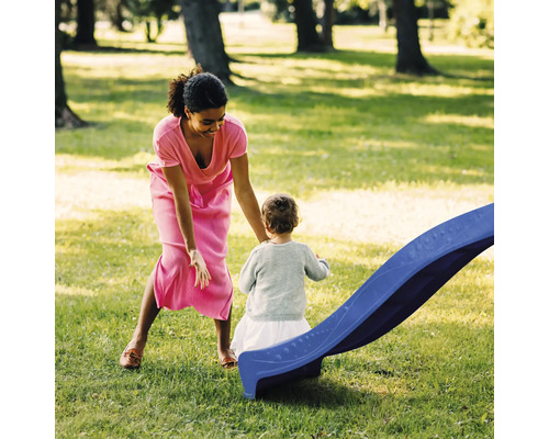 Mère et enfant à côté d''un toboggan pour enfants dans le jardin