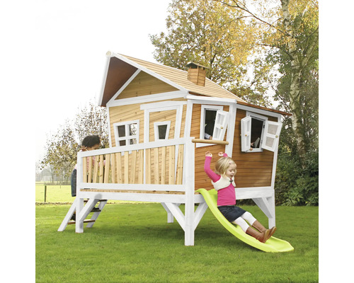 Cabane de jeu pour enfants avec toboggan et enfants dans le jardin