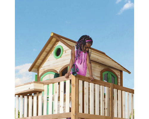 Enfant dans une cabane en bois avec des jumelles