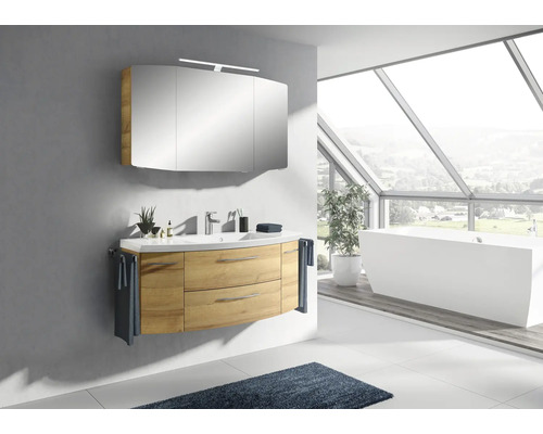 Salle de bain lumineuse avec meuble sous-lavabo, armoire de toilette et baignoire sous une grande fenêtre