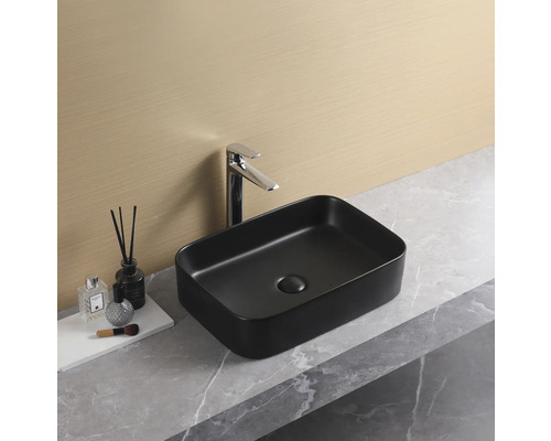 Schwarzes Aufsatzwaschbecken mit Armatur auf einer Waschtischplatte