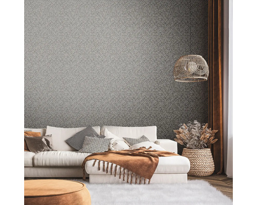 Salon avec papier peint à motifs, canapé et décorations pour une ambiance chaleureuse