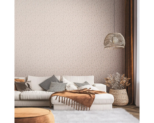 Salon avec canapé, coussins, couverture, lampe et papier peint à motifs floraux