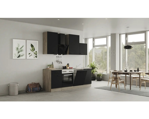 Cuisine moderne avec armoires noires, table à manger et chaises dans une pièce lumineuse.