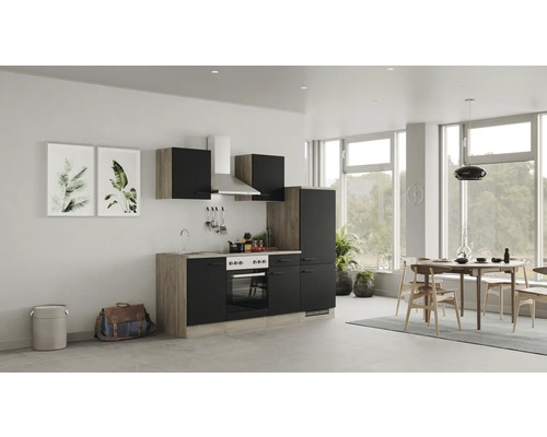 Cuisine claire avec kitchenette, table à manger et décoration dans une pièce lumineuse.