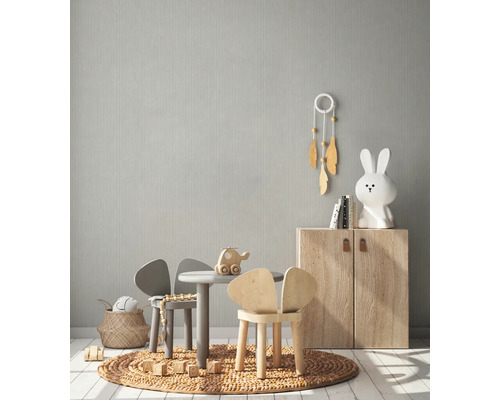 Chambre d''enfant lumineuse avec mobilier pour enfants, jouets et papier peint à motifs discrets.