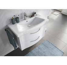 Salle de bains moderne avec meuble sous-lavabo, robinetterie et accessoires de salle de bains sur sol carrelé