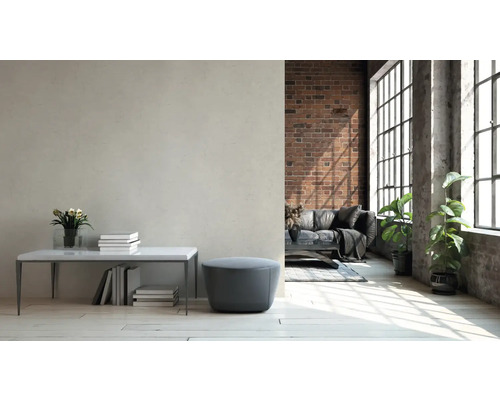 Helles Wohnzimmer mit Ziegelwand, Sofa und grossen Fenstern