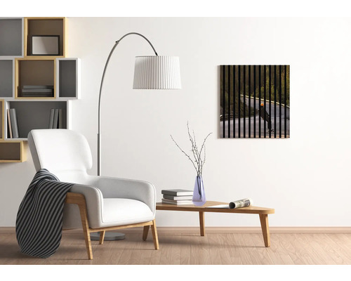 Salon avec fauteuil, lampadaire, table et tableau mural avec skateur