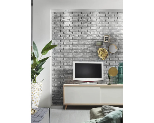 Salon avec mur de briques gris, télévision et buffet blanc