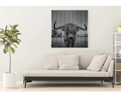 Wohnzimmer mit Sofa und Wandbild eines schottischen Hochlandrindes