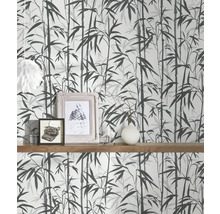 Tapete mit Bambusmuster an einer Wand mit Holzregal und Dekoration