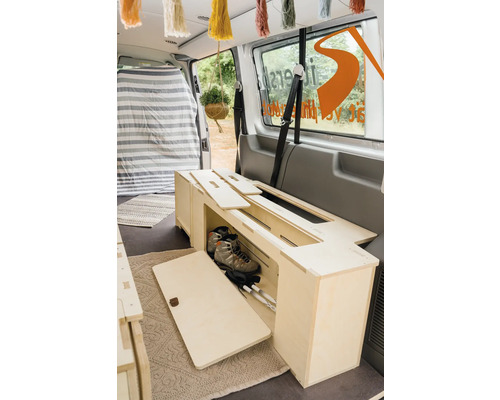 Aménagement intérieur d''une camionnette avec des meubles en bois.