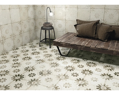 Beispielraum mit Fliesen mit Blumenmuster, Hocker, Tischlampe und Holzbank mit Kissen