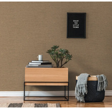 Gros plan d''un papier peint texturé dans un salon avec une petite table, une plante et des éléments décoratifs