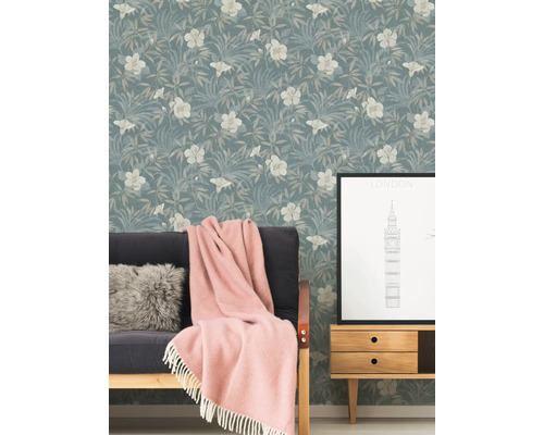 Espace de vie avec papier peint à motifs floraux, canapé, couverture et table d''appoint avec motif de Londres