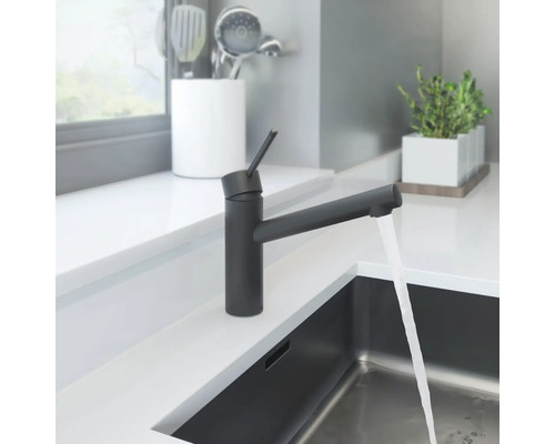 Robinet de cuisine noir avec eau courante dans une cuisine moderne.