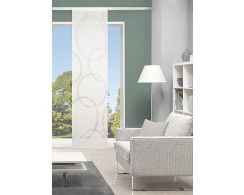 Salon avec rideau coulissant à motif de cercles, canapé, lampe et étagère