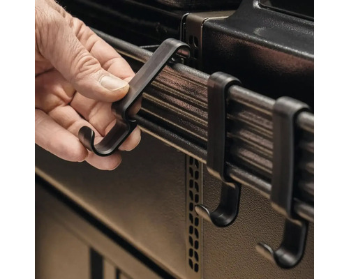 Person hängt Haken an Grillreling