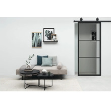 Salon avec canapé, tables basses, tableaux et porte coulissante