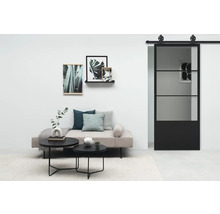 Salon avec lit de jour, table basse et porte coulissante en verre