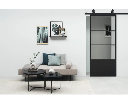 Salon avec lit de jour, table basse et porte coulissante en verre