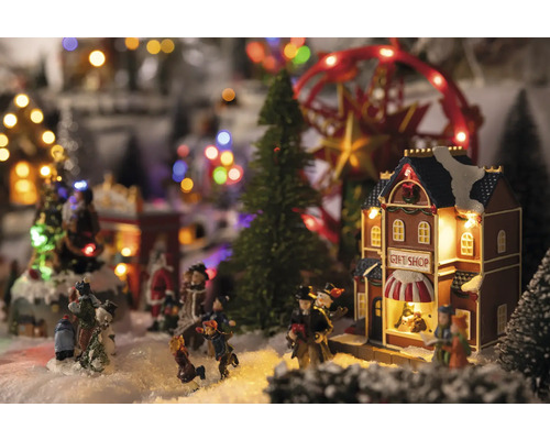 Weihnachtsdorf Szene mit Figuren, Bäumen, Karussell und Geschenk Shop