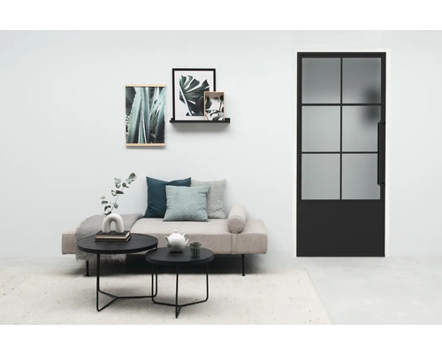 Salon avec canapé, table, tableaux et porte en verre avec cadre en acier