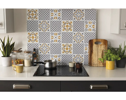 Scène de cuisine avec décor de carreaux derrière la zone de cuisson, planche à découper, casserole et herbes aromatiques