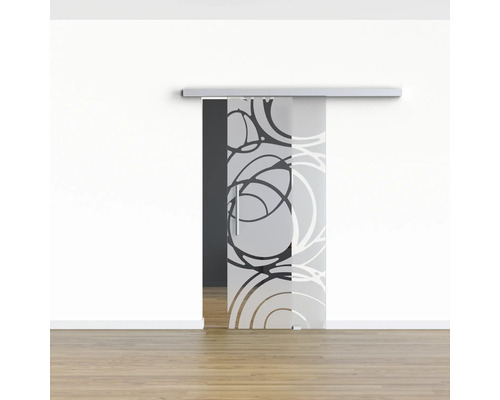 Porte coulissante en verre avec motif circulaire devant un mur blanc