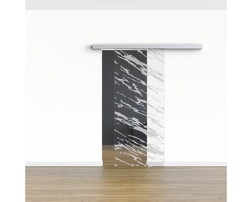 Glasschiebetür mit Muster vor einer weissen Wand und einem Holzboden