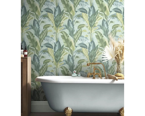 Badezimmer mit Badewanne und Dschungeltapete mit Pflanzenmotiven.
