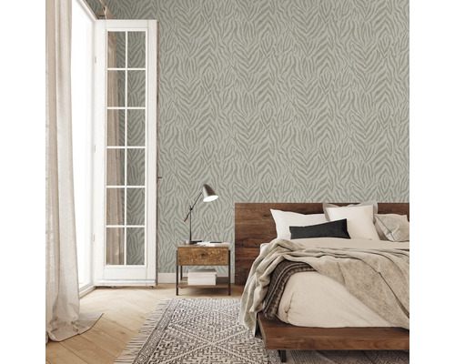 Chambre avec papier peint à motifs, lit, table de chevet et tapis
