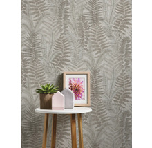 Pièce avec papier peint à motif de fougère, table d''appoint, plante d''intérieur et cadre photo