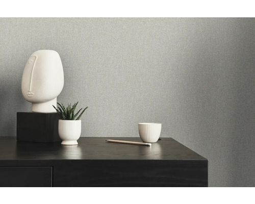Gros plan d''un papier peint intissé gris avec une décoration minimaliste sur une table