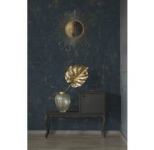 Scène décorative avec miroir, feuille de Monstera et console devant un mur à motifs