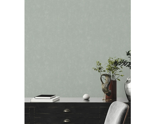 Gros plan d''un papier peint intissé gris avec une texture irrégulière.