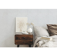 Schlafzimmer mit Nachttisch aus Holz, Tasse, Vase und gerahmtem Bild