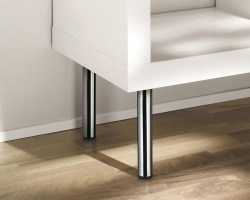 Detailansicht eines weißen Möbels mit Chromfüßen auf einem Holzboden