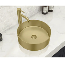 Un lavabo à poser avec robinet est placé sur un meuble-lavabo.