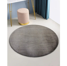 Tapis rond gris dans une pièce avec tabouret et table