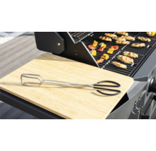Grillszene mit Grillzange, Schneidebrett, Grillgut