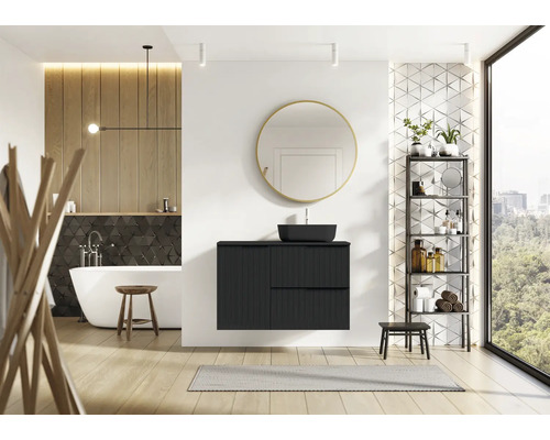 Salle de bain moderne avec meuble-lavabo noir, miroir, baignoire et étagère.