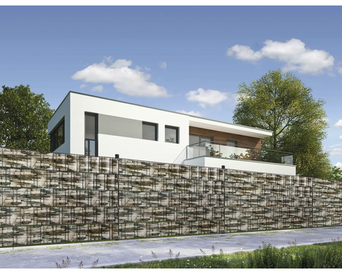 Mur de gabions avec remplissage en pierre devant une maison moderne